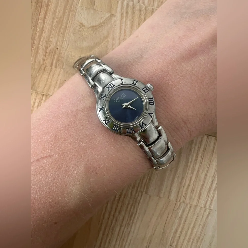 Caravelle by Bulova ladies blue dial silver tone dress watch NEW BATTERY